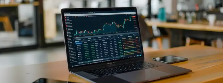 a bright laptop screen displaying a graph showing a sharp increase in website traffic and sales, with a smiling shopify seo expert in the background.